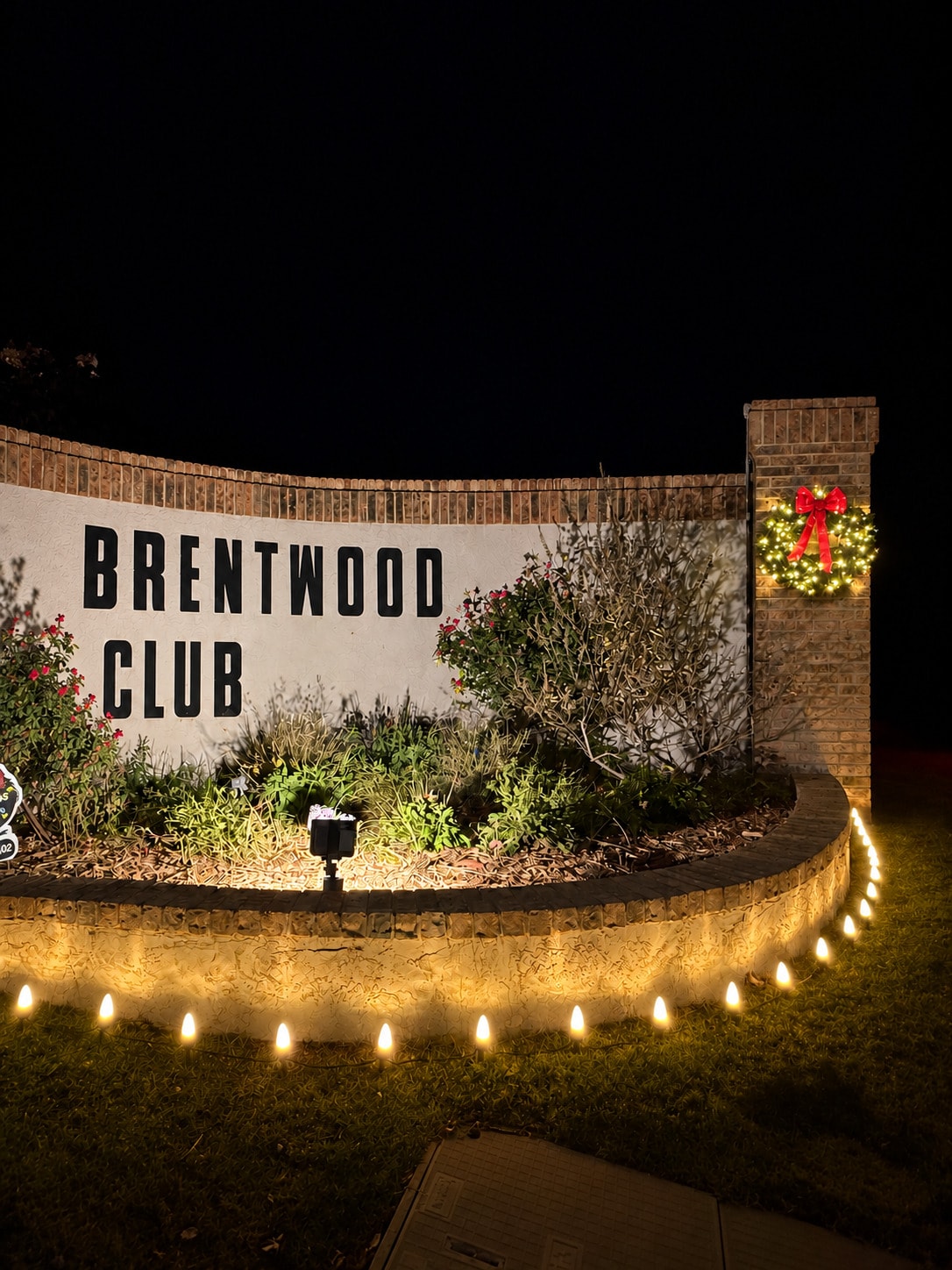 Apartment complex with warm white roofline holiday lighting