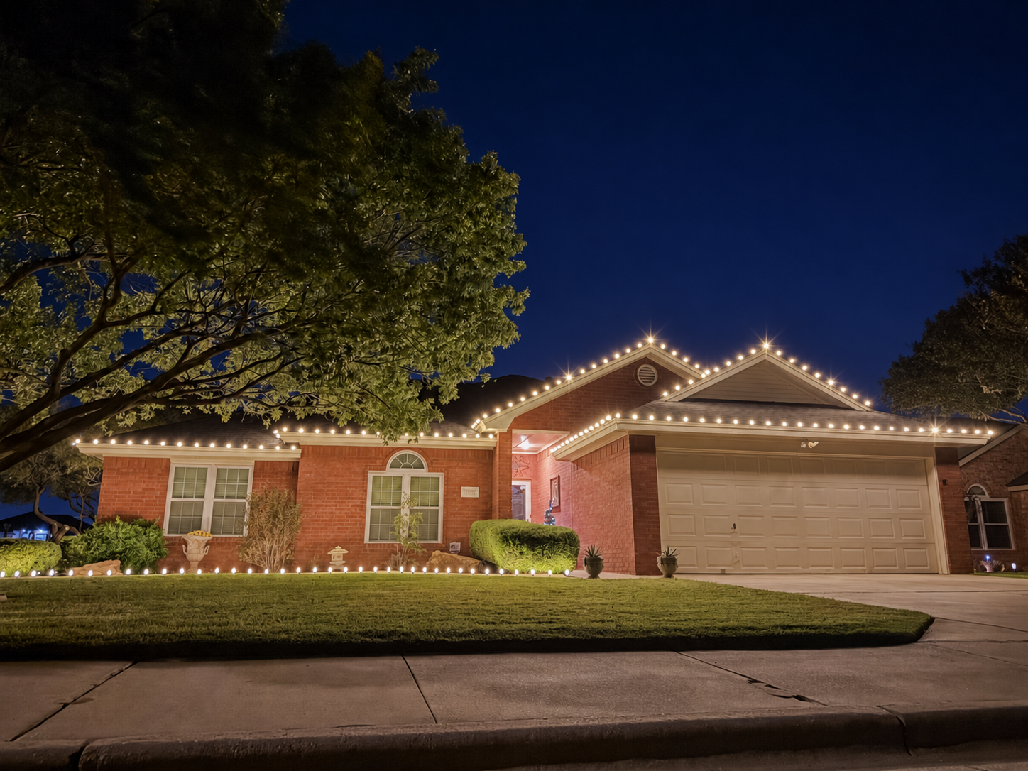 Professional installer hanging roofline holiday lights