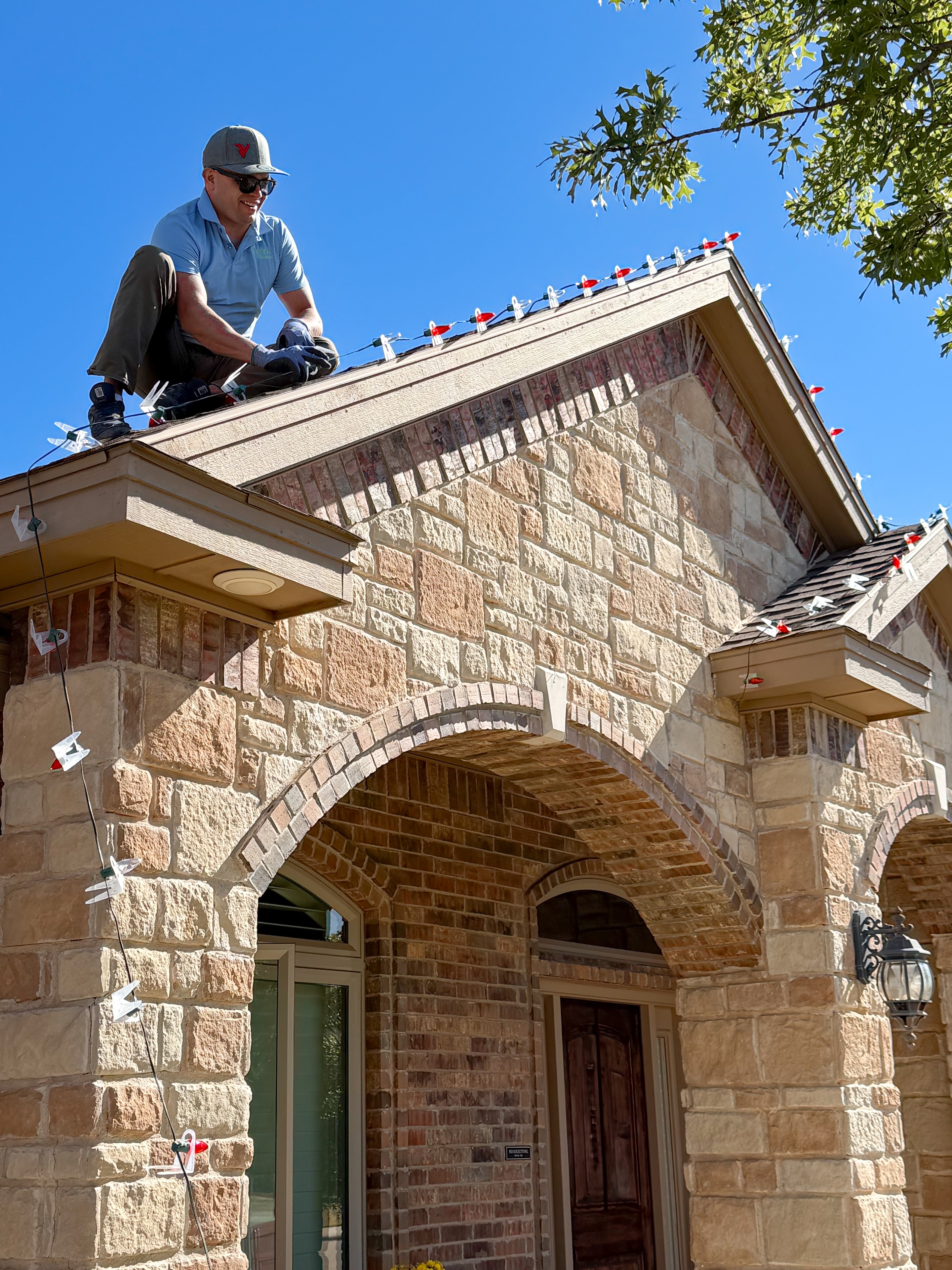 Professional installer preparing a residential holiday lighting display